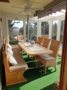 a table and chairs on a screened in porch at Hochgratstrasse in Oberreute