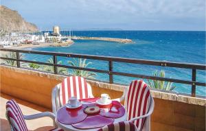 a table and chairs on a balcony overlooking the ocean at 2 Bedroom Cozy Apartment In Aguadulce in Aguadulce