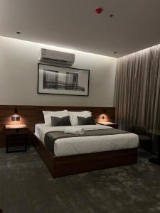 a bedroom with a bed with a air conditioner above it at سيفن سون للأجنحة الفندقية in Abha +56 photos