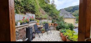 a patio with a bunch of plants and chairs at Haus Sonnentag in Bad Bertrich