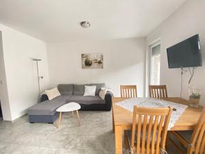 a living room with a couch and a table at Haus Sonnentag in Bad Bertrich