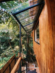 a glass roof over the door of a tree house at Greenspace Living in Ban Tha Phae
