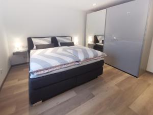 a bedroom with a large bed with a large mirror at Rhön - Nestchen in Unteralba