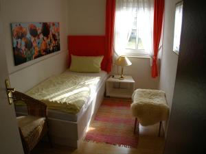 a small bedroom with a bed and a window at Park-Villa in Bad Steben