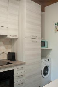 a kitchen with a washing machine and a washer and dryer at Il Borgo appartamento Luca in Parma