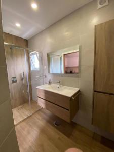 a bathroom with a sink and a shower at Apartamento Senhora da Rocha in Armação de Pêra