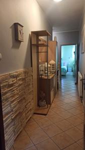 a hallway of a house with a tile floor and a kitchen at Wydmuchówka in Jurata +4 photos
