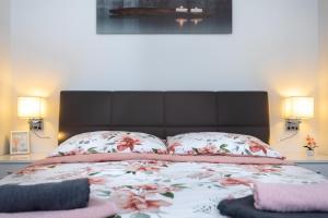 a bedroom with a large bed with two pillows at Apartman Oliva in Krk