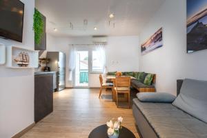a living room with a couch and a table at Apartman Oliva in Krk