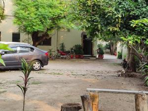a car parked in front of a house at Green Land Hotel Lahore in Lahore