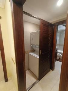 a door to a kitchen with a refrigerator at Luxury Apartment In Massaken Sheraton near Cairo Int'l Airport in Cairo