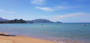 a view of a beach with boats in the water at Yulides home gardens in Cindakir