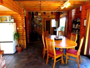 a dining room with a wooden table and chairs at Hanmer Backpackers in Hanmer Springs