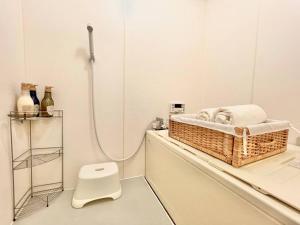 a bathroom with a basket of towels and a toilet at 久Hisashi池下店民泊 in Chikusachō