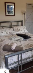 a bed with a blanket and pillows on it at Rowlands Castle No 41 in Rowlands Castle +8 photos