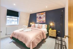a bedroom with two beds and a blue wall at Regent Grand Penthouse in Brighton & Hove