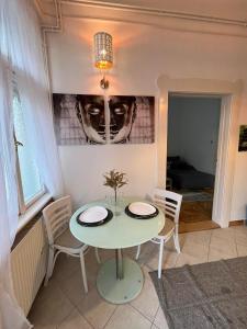 a dining room with a table and chairs at Szeged Apartman in Szeged