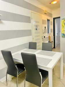 a dining room with a white table and chairs at Acciuga in Monterosso al Mare