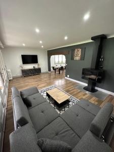 a living room with a couch and a piano at Gîte d'Esila in Saint-Aignan