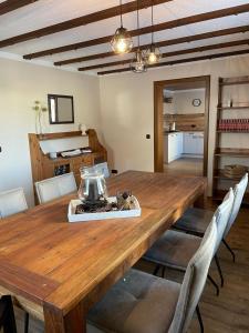 a dining room with a wooden table and chairs at Ferienhaus Janne in Monschau