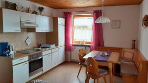 eine Küche mit einem Tisch und einem Esszimmer in der Unterkunft Moierhof in Treffelstein