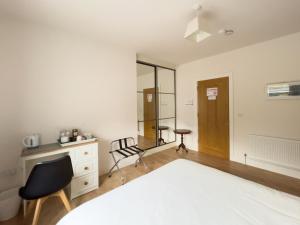 a bedroom with a bed and a desk and a chair at Woodview Lodge in Trim