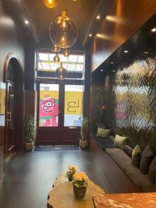 a lobby with a couch and a table and a window at La Bourse Hotel in Brussels