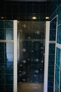 a bathroom with a shower with fish on the wall at Worthwhile-Days FeWo Kleinschwabhausen in Kleinschwabhausen