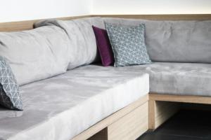 a gray couch with pillows on top of it at Athens Lodge by Athens Prime Hotels in Athens