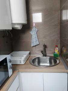 a kitchen counter with a sink and a microwave at Apartmani Milosevic in Kopaonik