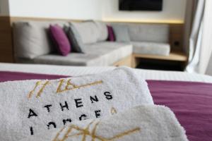 a hotel room with a bed with a welcome mat on it at Athens Lodge by Athens Prime Hotels in Athens