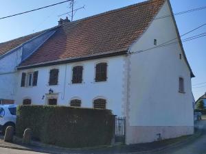 a large white building with a brown roof at Chambre Haut in Zilling