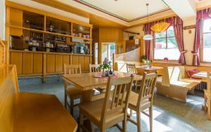 a dining room with wooden tables and chairs at Gasthof Pichler in Grimmenstein