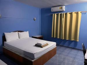 沙敦的住宿－Metro Palace，一间卧室配有一张蓝色墙壁的床