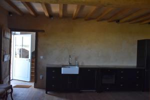 a kitchen with a sink and a counter top at Maison ou chambres dans une belle ferme lauragaise 