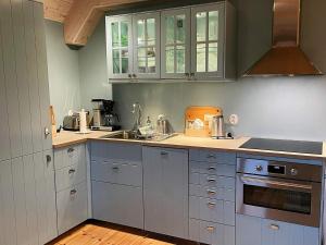 a kitchen with white cabinets and a sink at Holiday home Löderup V in Löderup +18 photos