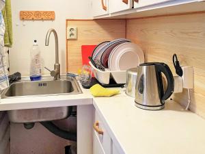 a kitchen with a sink and a counter with dishes at Holiday home SEXDREGA in Sexdrega