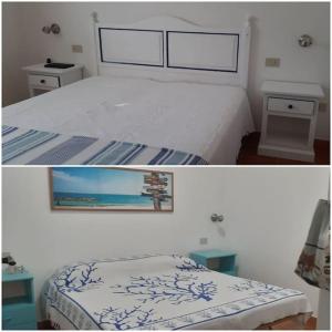 a bedroom with a bed and a picture of the ocean at Casa Serena in San Vito lo Capo