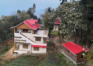 an overhead view of a house with a red roof at Bloomfield Farmhouse and Eco-Resort in Darjeeling