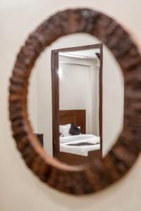 a mirror reflection of a bed in a bedroom at The Lodgers 2 BHK Serviced Apartment infront of Artemis Hospital Gurgaon in Gurgaon