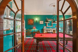 una mesa de billar roja en una habitación con paredes verdes en Springwells House en Steyning