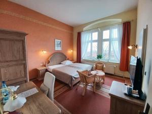 um quarto de hotel com uma cama e uma janela em Schlossberg-Hotel Garni em Wernigerode
