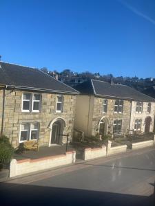 a row of brick houses on a street at Dunarle Guesthouse in Oban