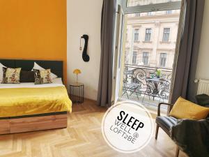 a bedroom with a bed and a window with a view at Loft2Be, Vienna City Loft for 8 in Vienna