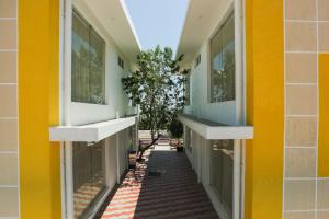 a hallway of a building with yellow walls and windows at Belair Resorts in Kotagiri