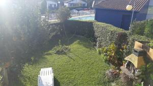 an aerial view of a garden with a white chair at INIGO in Hendaye