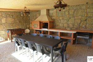 a dining room with a table and chairs and a fireplace at Casa da Moda - Turismo de Campo in Vieira do Minho