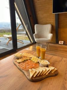 a tray of food on a table with bread and drinks at Loon Moon Mountain Chalets in Sarajevo
