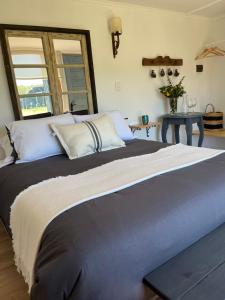 a bedroom with a large bed with a laptop on it at Nenquen Lodge in Santa Cruz