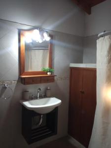 y baño con lavabo y espejo. en El Quincho en Gualeguay